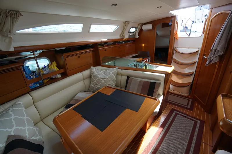 Slide: The Image of Teak deck of 2004 Jeanneau Sun Odyssey 37 sailboat, showcasing polished wood finish. - 7