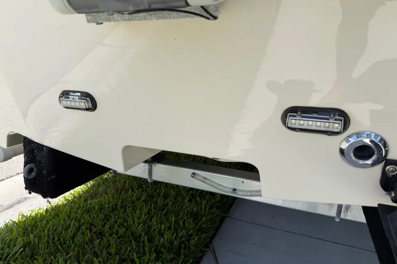 Slide: The Image of 2023 Carolina Skiff 21 LS boat stern with LED lights and trailer detail. - 16