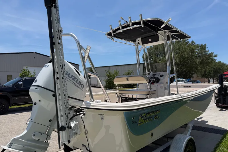 Slide: The Image of 2023 Carolina Skiff 21 LS boat with Suzuki outboard motor, parked outdoors. - 19