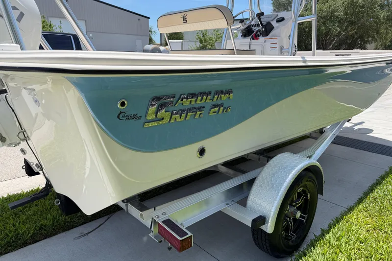 Slide: The Image of 2023 Carolina Skiff 21 LS boat on trailer, side view, outdoors. - 20