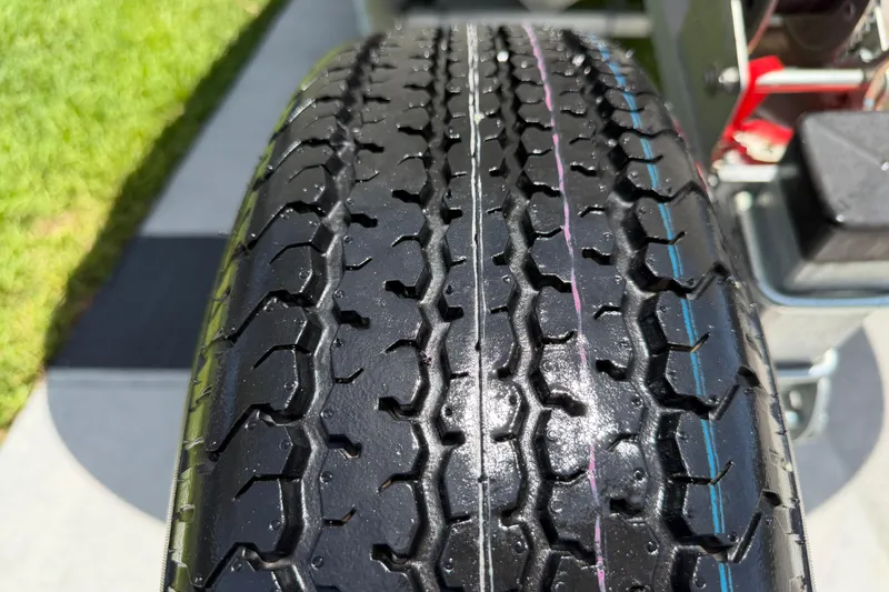 Slide: The Image of Close-up of a 2023 Carolina Skiff 21 LS trailer tire with detailed tread pattern. - 33
