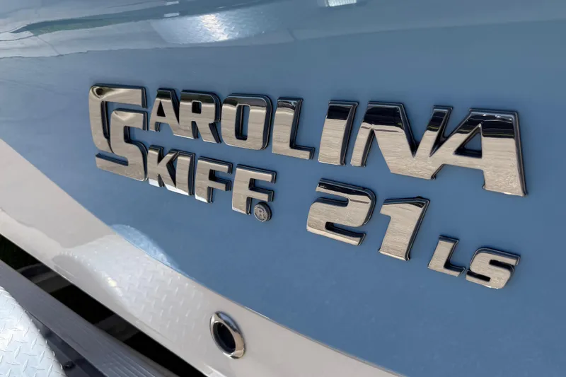 Slide: The Image of 2023 Carolina Skiff 21 LS logo on a light blue boat surface. - 4