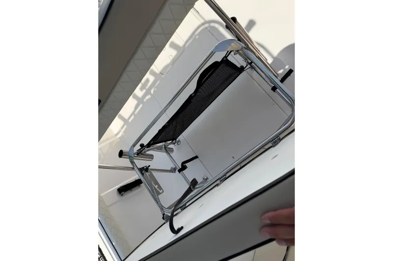 Slide: The Image of 2023 Carolina Skiff 21 LS boat interior with foldable seat and storage compartment. - 45