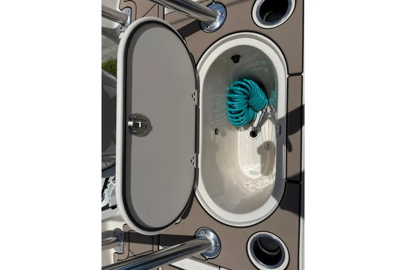 Slide: The Image of 2023 Carolina Skiff 21 LS boat storage compartment with coiled hose inside. - 46