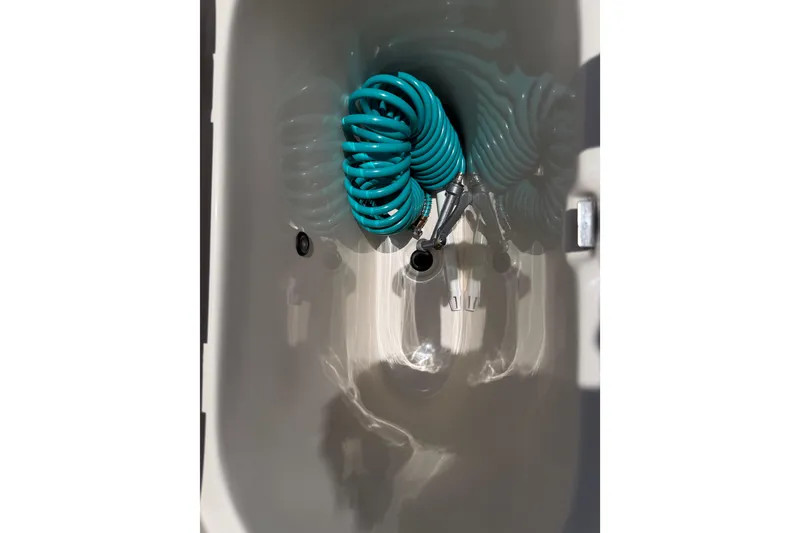 Slide: The Image of Coiled blue hose in 2023 Carolina Skiff 21 LS boat compartment. - 47