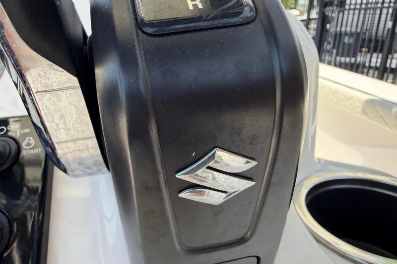 Slide: The Image of Close-up of 2023 Carolina Skiff 21 LS boat throttle control with Suzuki logo. - 54