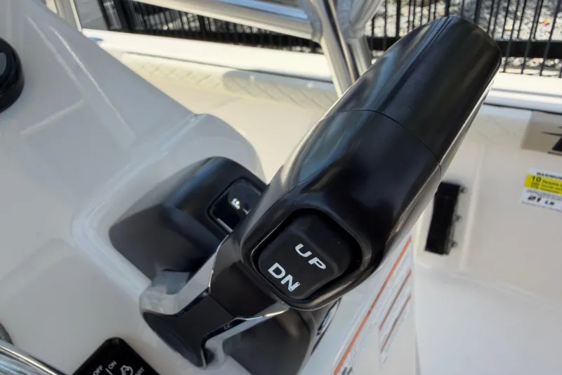 Slide: The Image of Close-up of 2023 Carolina Skiff 21 LS throttle control with "UP" and "DN" buttons. - 55