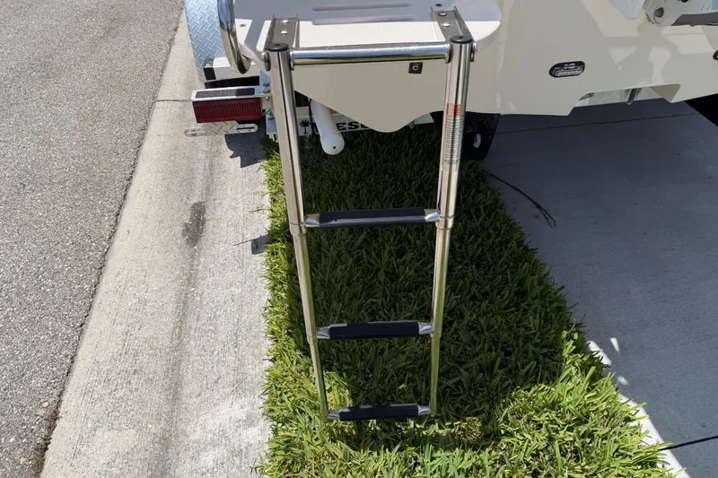 Slide: The Image of 2023 Carolina Skiff 21 LS boat ladder on grass beside pavement. - 6