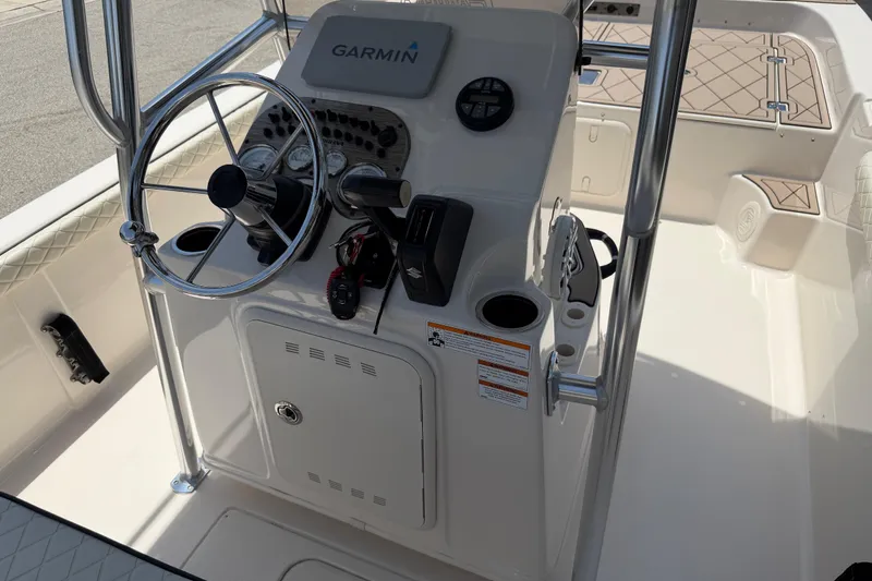 Slide: The Image of 2023 Carolina Skiff 21 LS boat console with Garmin navigation system and steering wheel. - 62