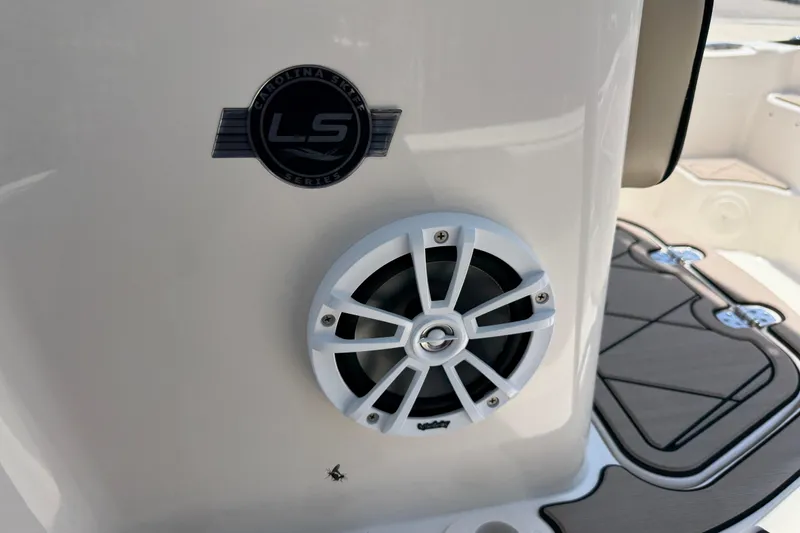 Slide: The Image of 2023 Carolina Skiff 21 LS boat interior with speaker and LS series logo. - 67