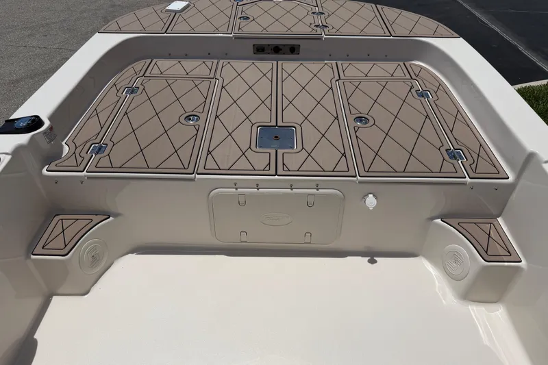 Slide: The Image of 2023 Carolina Skiff 21 LS boat deck with tan diamond-patterned hatches and storage compartments. - 68