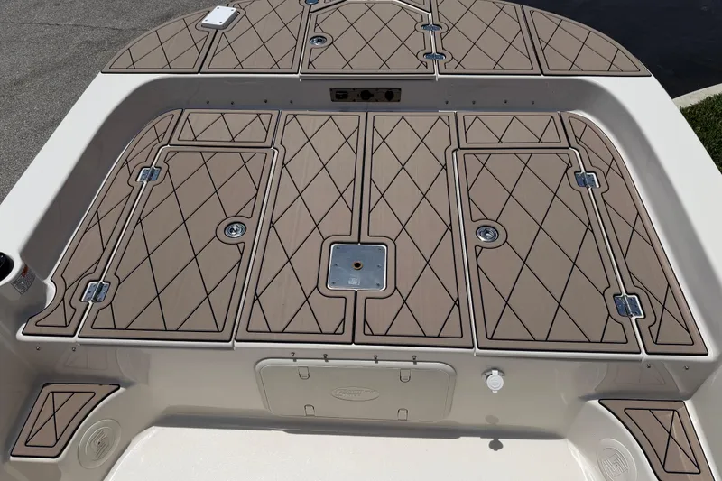Slide: The Image of 2023 Carolina Skiff 21 LS boat deck with diamond-patterned storage hatches. - 69