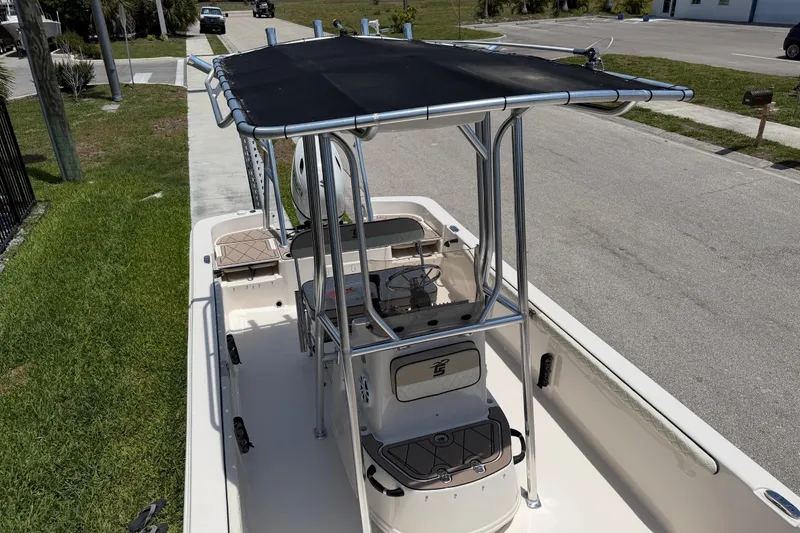 Slide: The Image of 2023 Carolina Skiff 21 LS boat with T-top, parked on a sunny street. - 74