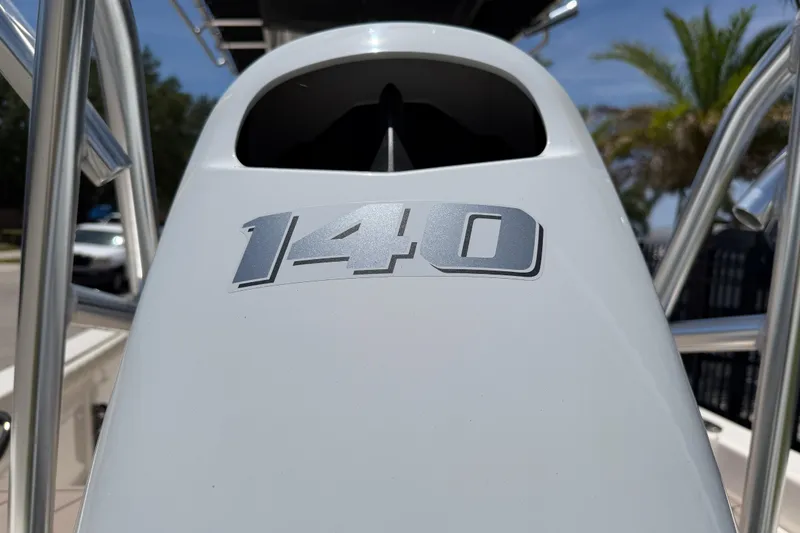 Slide: The Image of Close-up of 2023 Carolina Skiff 21 LS boat with '140' emblem, sunny day background. - 8