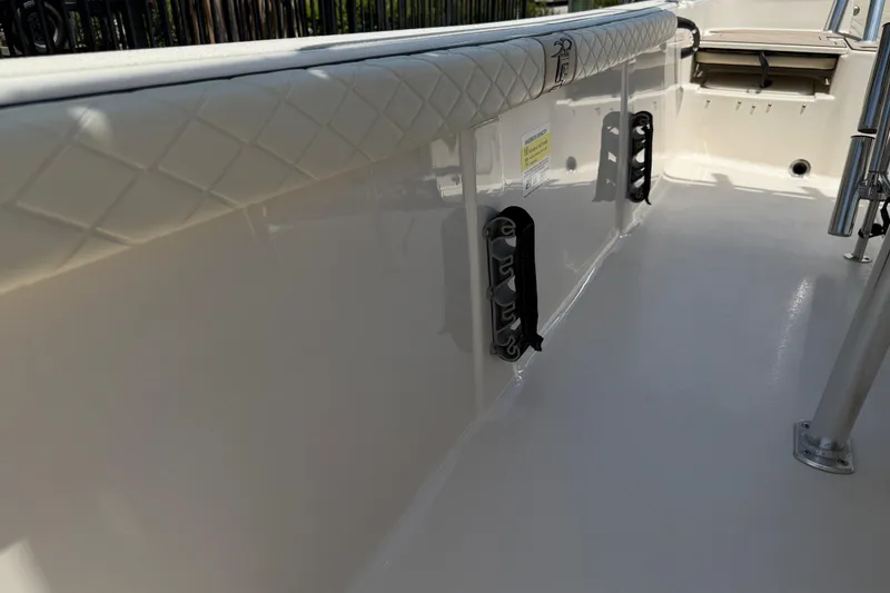 Slide: The Image of 2023 Carolina Skiff 21 LS boat interior with quilted upholstery and rod holders. - 82