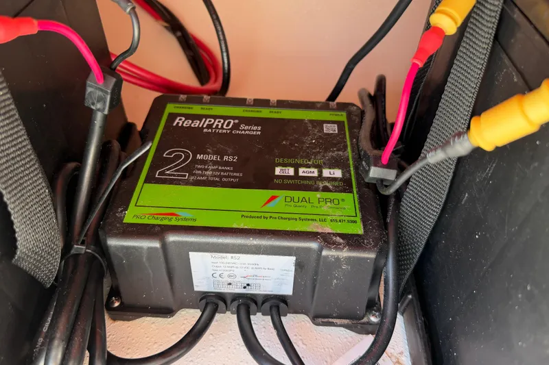 Slide: The Image of Battery charger in a 2023 Carolina Skiff 21 LS boat, featuring RealPRO Series Model RS2. - 85