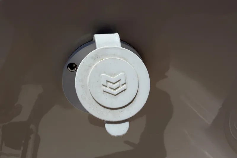 Slide: The Image of Close-up of a 2023 Carolina Skiff 21 LS boat component with a white circular cover. - 86