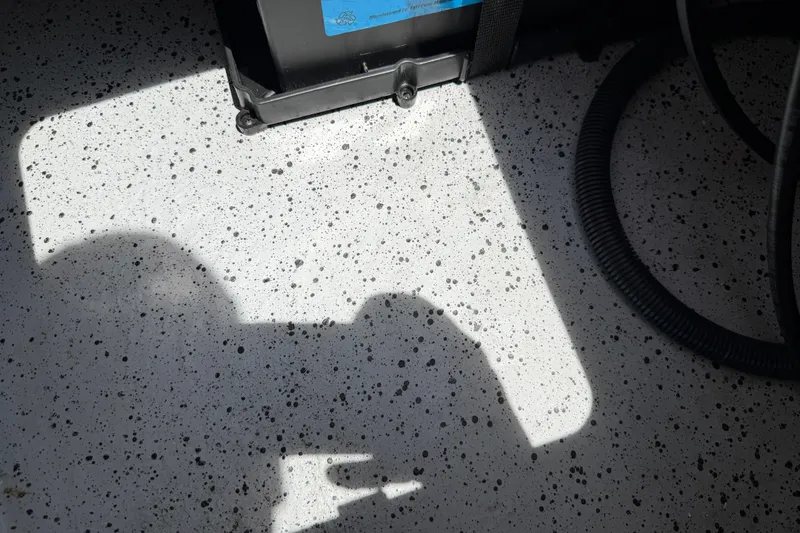 Slide: The Image of Shadow on speckled surface of 2023 Carolina Skiff 21 LS boat interior. - 92