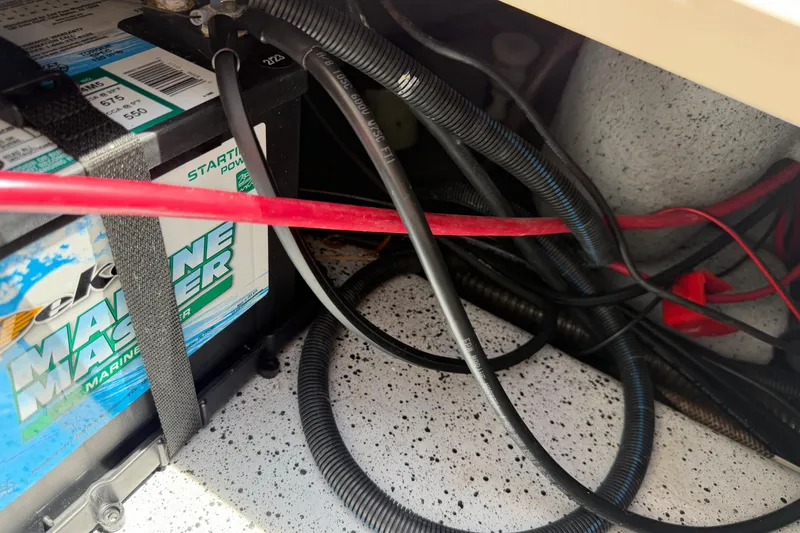 Slide: The Image of Battery compartment of 2023 Carolina Skiff 21 LS with cables and wiring. - 93
