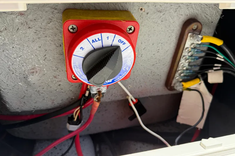 Slide: The Image of Battery switch and wiring inside a 2023 Carolina Skiff 21 LS boat. - 94
