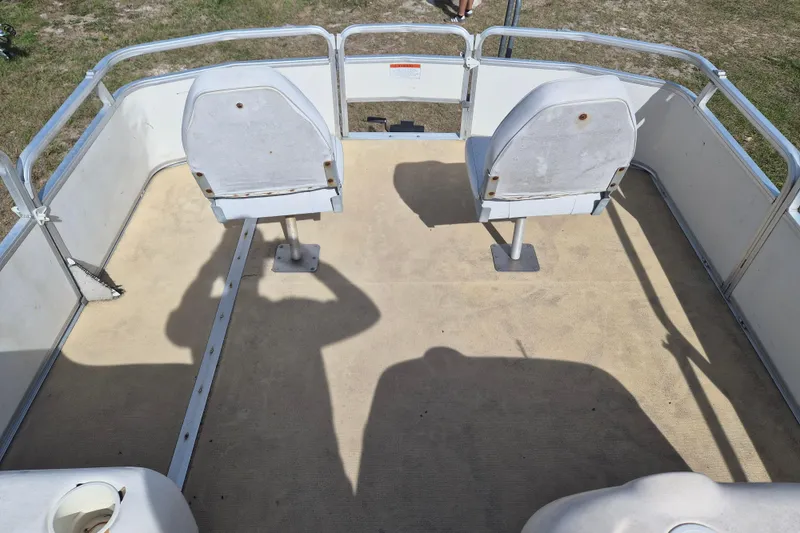 Slide: The Image of 2004 Sun Tracker Fishin' Barge 20 DLX deck with two swivel seats and railing. - 11