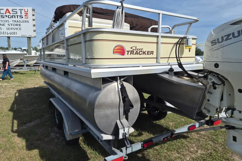 Slide: The Image of 2004 Sun Tracker Fishin' Barge 20 DLX pontoon boat on trailer, outdoor display. - 4