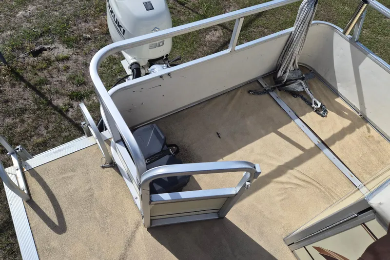 Slide: The Image of 2004 Sun Tracker Fishin' Barge 20 DLX deck with Suzuki outboard motor and rope. - 5
