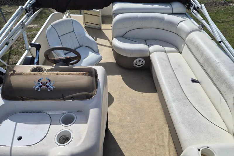 Slide: The Image of 2004 Sun Tracker Fishin' Barge 20 DLX interior with spacious seating and steering console. - 6