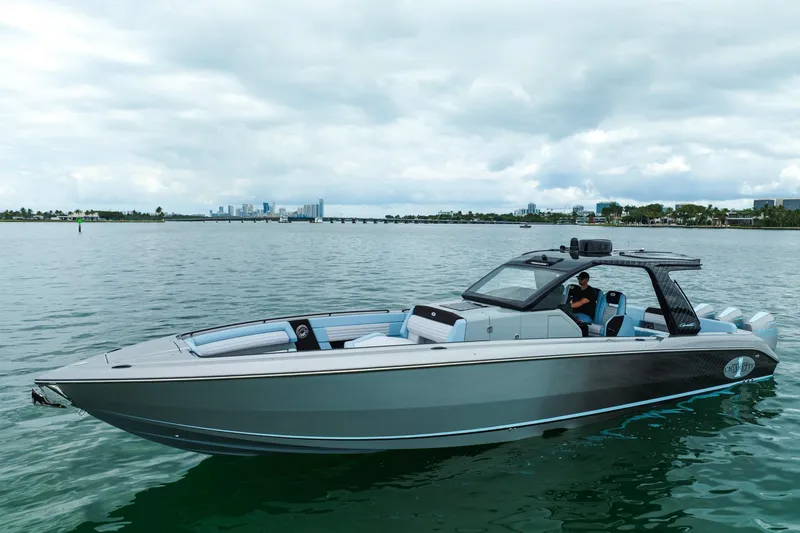 The Image of 2026 Cigarette 41' Nighthawk boat on calm water with city skyline in background. - 0