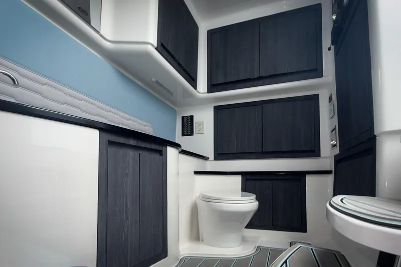 Slide: The Image of Modern bathroom interior of 2026 Cigarette 41' Nighthawk boat, featuring sleek cabinetry and fixtures. - 11