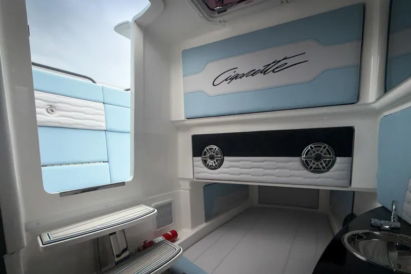 Slide: The Image of Interior of 2026 Cigarette 41' Nighthawk boat with stylish blue and white seating. - 13