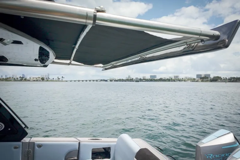 Slide: The Image of 2026 Cigarette 41' Nighthawk boat on water, city skyline in background. - 15
