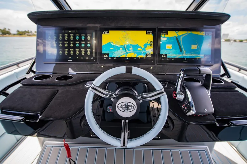 Slide: The Image of 2026 Cigarette 41' Nighthawk dashboard with advanced navigation screens and steering wheel. - 6