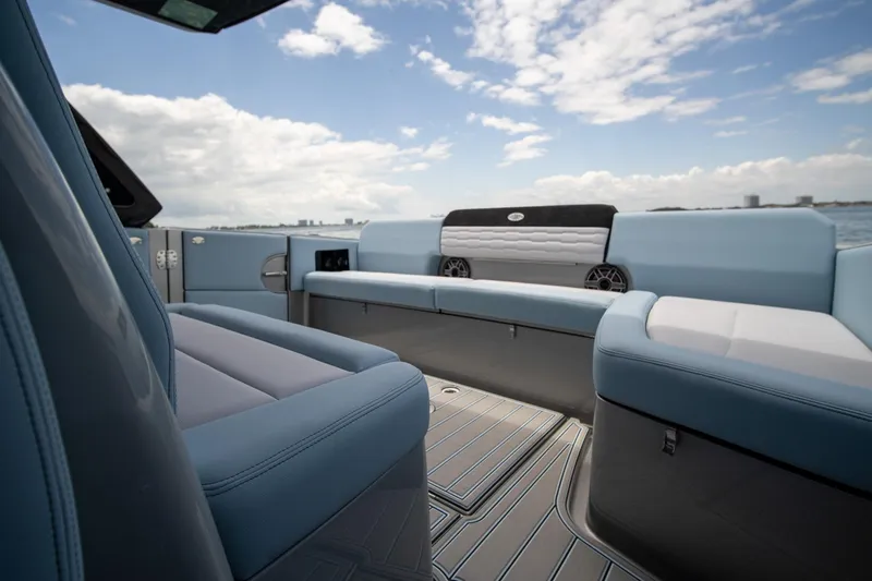 Slide: The Image of 2026 Cigarette 41' Nighthawk boat interior with blue seating and ocean view. - 7