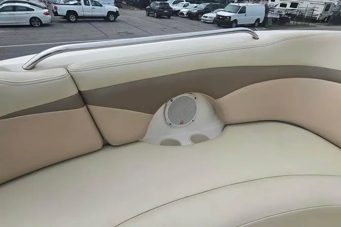 Slide: The Image of 2003 Chaparral Sunesta 236 boat interior with beige seating and built-in speaker. - 10