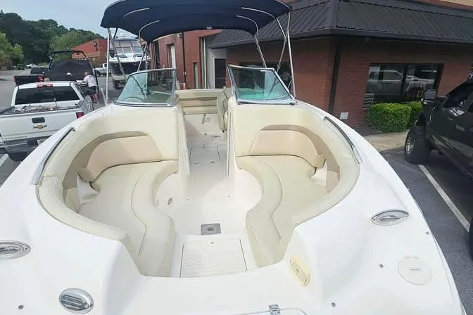 Slide: The Image of 2003 Chaparral Sunesta 236 boat with spacious seating and canopy in a parking lot. - 13