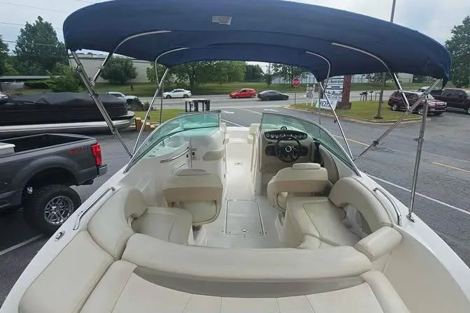 Slide: The Image of 2003 Chaparral Sunesta 236 boat with blue canopy and spacious seating. - 14