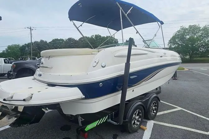 Slide: The Image of 2003 Chaparral Sunesta 236 boat on trailer with blue canopy in parking lot. - 5