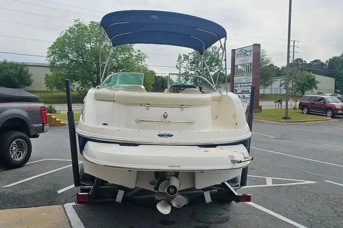 Slide: The Image of 2003 Chaparral Sunesta 236 boat with blue canopy in parking lot. - 7
