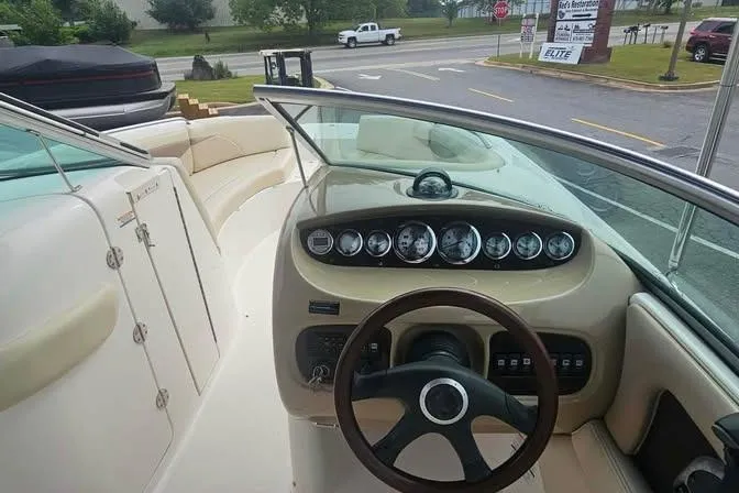 Slide: The Image of 2003 Chaparral Sunesta 236 boat interior with steering wheel and dashboard controls. - 9