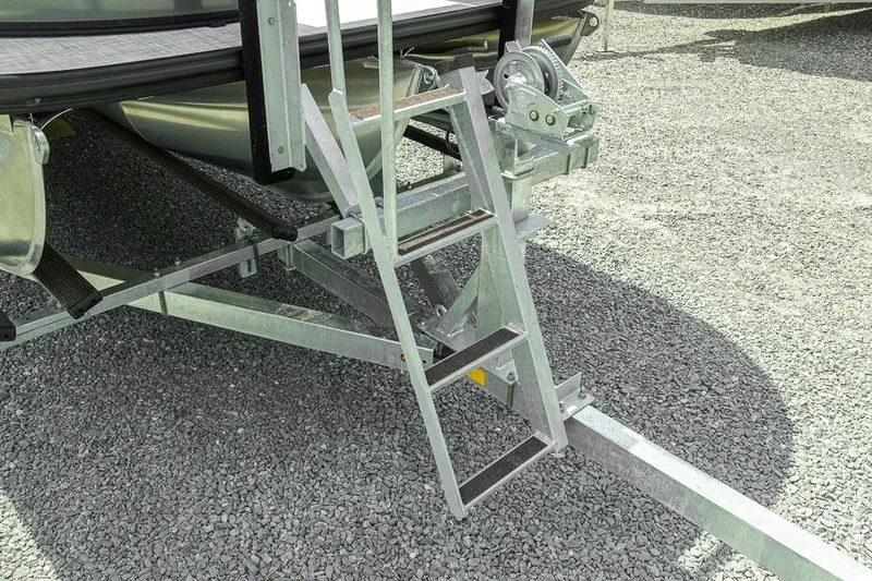Slide: The Image of Metal ladder on Dockside 22DF boat trailer, 2026 model, on gravel surface. - 11