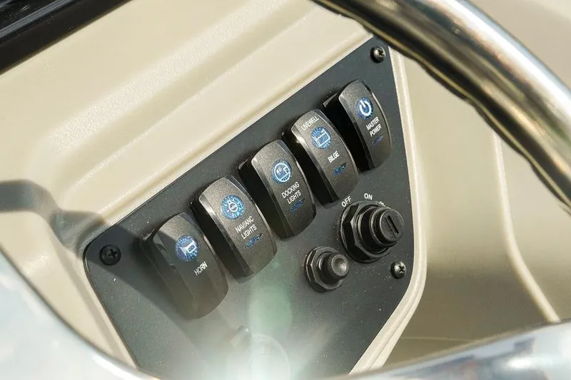 Slide: The Image of Control panel of Dockside 22DF boat, featuring switches for horn, lights, and power. - 16
