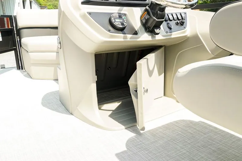 Slide: The Image of Interior view of 2026 Dockside 22DF boat console with open storage compartment. - 28