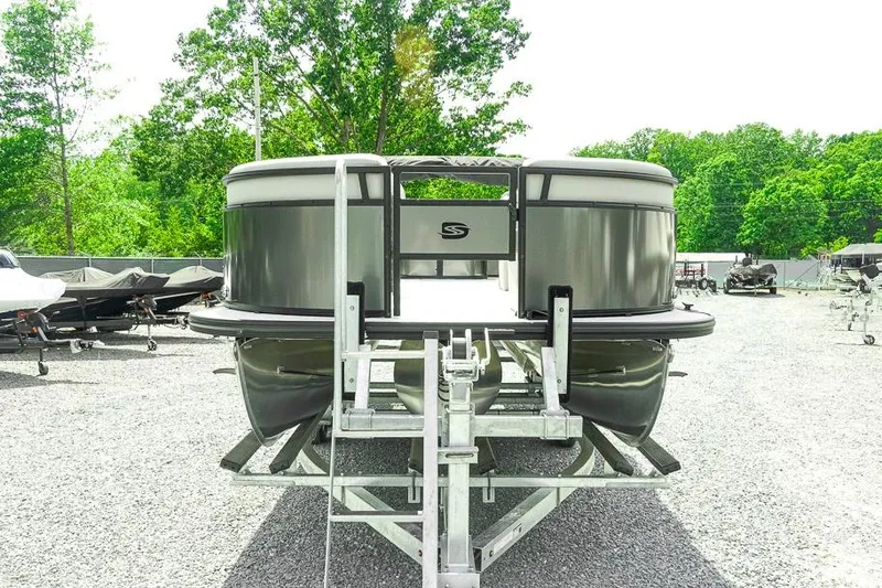 Slide: The Image of 2026 Dockside 22DF pontoon boat on trailer, surrounded by trees and other boats. - 3