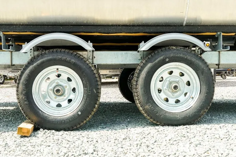 Slide: The Image of Trailer wheels on a 2026 Dockside 22DF, parked on gravel. - 31