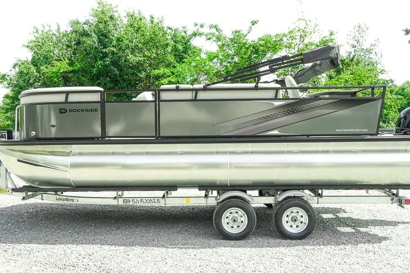 Slide: The Image of 2026 Dockside 22DF pontoon boat on trailer, surrounded by greenery. - 4