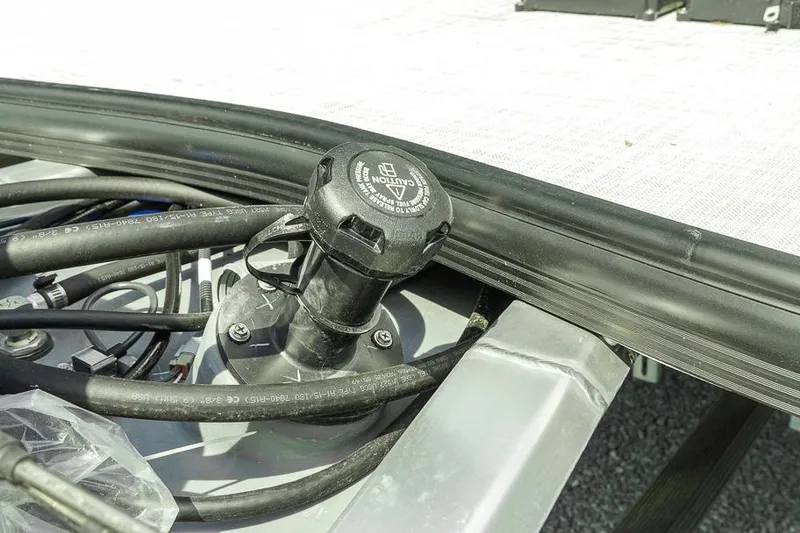 Slide: The Image of Fuel cap and hoses on a 2026 Dockside 22DF boat deck. - 6