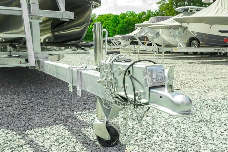 Slide: The Image of Trailer hitch of a 2026 Dockside 22DF boat trailer in a gravel lot. - 9
