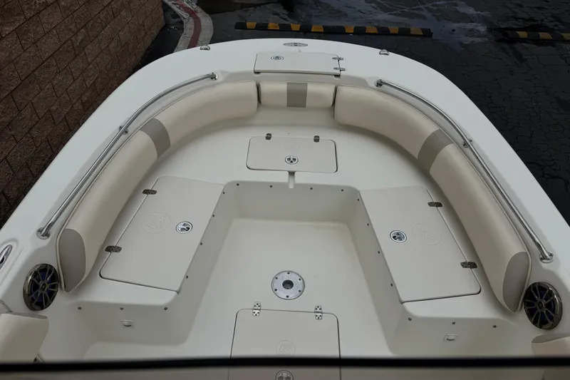 Slide: The Image of 2014 Carolina Skiff 23 Ultra Elite SS boat interior with cushioned seating and storage compartments. - 12