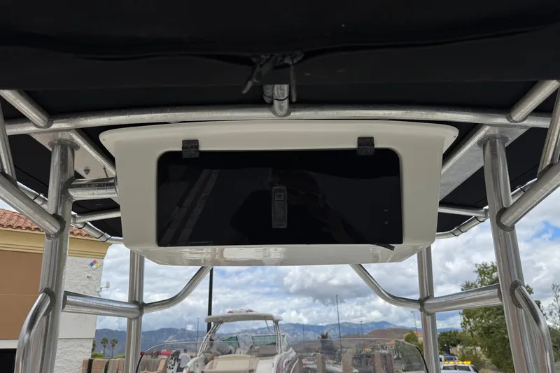 Slide: The Image of 2014 Carolina Skiff 23 Ultra Elite SS boat console with overhead storage compartment. - 17